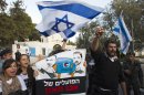 Israeli ultranationalist right-wing protesters hold a placard during a demonstration near Jerusalem