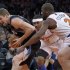 Timberwolves' Andrei Kirilenko reacts as he tries to get past Knicks' Carmelo Anthony and Raymond Felton during their NBA game in New York