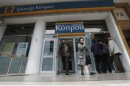 People leave a Bank of Cyprus branch in Athens