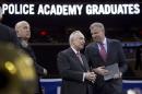 Blasio speaks with Bratton on stage during the New York City Police Academy Graduating class ceremony in New York