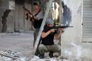 Rebel fighters hold a position on a front line in the Damascus suburb of Yalda on September 18, 2013