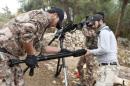 Rebel fighters prepare to fire a machine gun towards forces loyal to Syria's President Bashar al-Assad in the Jabal al-Akrad area in Syria's northwestern Latakia province