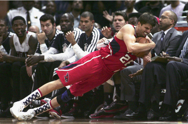Atlanta Hawks' Korver falls onto the Miami Heat bench during their NBA basketball game in Atlanta