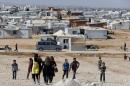 Syrian refugees walk at Al Zaatari refugee camp in the Jordanian city of Mafraq