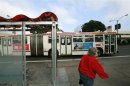A passenger walks to catch a bus at a solar powered bus stop in San Francisco