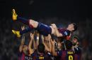 FC Barcelona's Lionel Messi, from Argentina, is lifted by his teammates after scoring against Sevilla during a Spanish La Liga soccer match between FC Barcelona and Sevilla, at the Camp Nou stadium in Barcelona, Spain, Saturday, Nov. 22, 2014. Messi set a La Liga scoring record of 253 goals when he claimed a hat-trick in Saturday's match at the Camp Nou stadium against Sevilla. (AP Photo/Manu Fernandez)