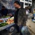 Dissident Chinese artist Ai Weiwei buys fruit on the street outside the Chaoyang District Court in Beijing