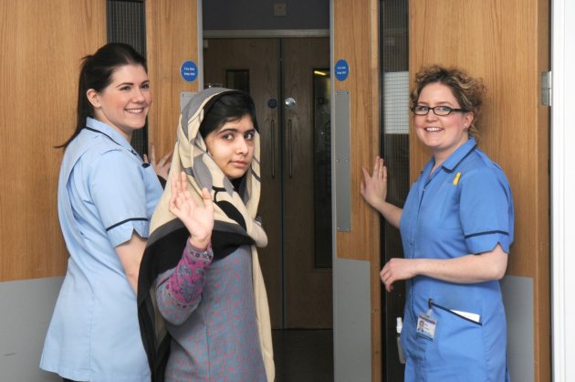 This photo made available by Queen Elizabeth Hospital, Birmingham, England shows Malala Yousufzai saying goodbye as she is discharged from the hospital to continue her rehabilitation at her family’s temporary home in the area, Friday, Jan. 4, 2013. the teenage Pakistani girl shot in the head by the Taliban for promoting girls' education has been released from the hospital after impressing doctors with her strength. Queen Elizabeth Hospital Birmingham officials said Friday 15-year-old Malala Yousufzai will be treated as an outpatient before being readmitted for further cranial re-constructive surgery at the end of the month or in early February. (AP Photo/Queen Elizabeth Hospital Birmingham)