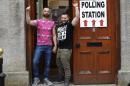 Partners Adrian, left and Shane, arrive to cast their vote at a polling station in Drogheda, Ireland, Friday, May 22, 2015. Ireland began voting Friday in a referendum on Gay marriage which will require an amendment to the Irish constitution. Opinion polls throughout the two-month campaign suggest the government-backed amendment should be approved by the required majority of voters when results are announced Saturday. (AP Photo/Peter Morrison)