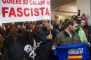 Spanish students and fishermen hold a banner reading "The fishing sector wants his fishing area. Picardo fascist" as they disrupt a conference of Chief Minister of Gibraltar Fabian Picardo in Algeciras on November 28, 2013