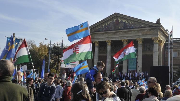 Participants of a march for Szekler autonomy, organized in support of the Great March of the Szeklers in central Romania's Szekler Land, gather at Heroes Square, in Budapest, Hungary carrying Hungarian and Szekler flags, on Sunday, Oct. 27, 2013. Szeklers are ethnic Hungarians living in the eastern part of Transylvania, Romania. The Great March of the Szeklers was organized by the Szekler National Council of Romania on the same day. (AP Photo/MTI,Attila Kovacs)