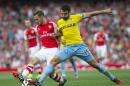 Arsenal's Aaron Ramsey, left, fights for the ball with Crystal Palace's Mile Jedinak during their English Premier League soccer match at Emirates Stadium, in London, Saturday, Aug. 16, 2014. (AP Photo/Bogdan Maran)