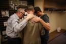 SPU President Dan Martin, center, prays with university trustee Matt Whitehead and Geoff Smith, right, in the Free Methodist church after a shooting at Seattle Pacific University on Thursday, June 5, 2014. A man that shot students was disarmed by others at the scene. (AP Photo/seattlepi.com, Joshua Trujillo)