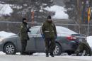 Police officers patrol the perimeter at the scene of a fatal shooting at the Quebec Islamic Cultural Centre in Quebec City