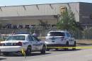 Police vehicles are seen outside a UPS service center following a deadly shooting in Birmingham, Alabama
