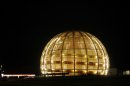 FILE - In this March 30, 2010 file picture the globe of the European Organization for Nuclear Research, CERN, is illuminated outside Geneva, Switzerland. The world's largest and most powerful atom smasher goes into a 2-year hibernation in March 2013 , aiming to reach maximum energy levels that may lead to more stunning discoveries after hunting down the so-called "God particle. But physicists at the European Center for Nuclear Research, known by its French acronym CERN, won't exactly be idle as the US $10 billion proton collider goes on hiatus for maintenance and retooling _ in preparation for unlocking more mysteries. There are still reams more data to sift through since the July 2012 discovery of a new subatomic particle called a Higgs boson and promises a new realm of understanding in subatomic science. (AP Photo/Anja Niedringhaus,File)
