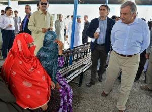 Head of the UNHCR Antonio Guterres (R) looks on during …