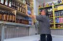 A shopkeeper arranges bottles in a shop in the Zayouna area of the Iraqi capital Baghdad, on May 15, 2013