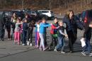 FILE - In this photo provided by the Newtown Bee, Connecticut State Police lead a line of children from the Sandy Hook Elementary School in Newtown, Conn. on Friday, Dec. 14, 2012 after a shooting at the school. Recordings of 911 calls from the Newtown school shooting are being released Wednesday Dec. 4, 2013, days after a state prosecutor dropped his fight to continue withholding them despite an order to provide them to The Associated Press. (AP Photo/Newtown Bee, Shannon Hicks, File) MANDATORY CREDIT: NEWTOWN BEE, SHANNON HICKS