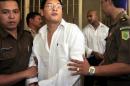 Australian drug smugglers Andrew Chan (C) and by Myuran Sukumaran (R, in white), are escorted by prison guards following a court hearing in Denpasar, on Bali island, Indonesia, February 14, 2006