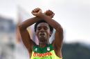 Ethiopia's Feyisa Lilesa crossed his arms above his head at the finish line of the men's marathon in Rio de Janeiro on August 21, 2016