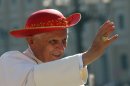 FILE - This Sept. 6, 2006 file photo shows Pope Benedict XVI wearing a "saturno hat", inspired by the ringed planet Saturn, to shield himself from the sun as he waves to the crowd of faithful prior to his weekly general audience in St. Peter's Square at the Vatican. (AP Photo/Pier Paolo Cito, files)