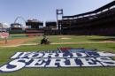 Grounds crew workers prepare the field before a baseball practice, Friday, Oct. 25, 2013, in St. Louis. The St. Louis Cardinals and Boston Red Sox are set to play Game 3 of the World Series on Saturday in St. Louis. (AP Photo/Charlie Neibergall)