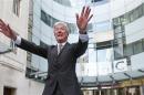 Tony Hall poses for photographers on his arrival at Broadcasting House for his first day as the new Director General of the BBC, in central London