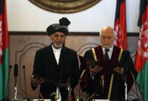 Afghanistan's new President Ashraf Ghani Ahmadzai stands next to Afghanistan's Chief Justice Abdul Salam Azimi as he takes the oath during his inauguration as president in Kabul