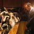 Photographers take photos of Olympic athlete Oscar Pistorius as he stands in the dock during his bail hearing at the magistrates court in Pretoria, South Africa, Friday, Feb. 22, 2013. The fourth and likely final day of Oscar Pistorius' bail hearing opened on Friday, with the magistrate then to rule if the double-amputee athlete can be freed before trial or if he has to remain in custody over the shooting death of his girlfriend. (AP Photo/Themba Hadebe)