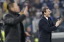 Juventus coach Massimiliano Allegri, right, applauds as Atletico's coach Diego Simeone gestures during a Champions League, Group A, soccer match between Juventus and Atletico de Madrid at the Juventus stadium in Turin, Italy, Tuesday, Dec. 9, 2014. (AP Photo/Antonio Calanni)
