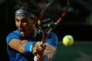 Spain's Rafael Nadal returns a backhand to Britain's Andy Murray during their match at the Italian open tennis tournament in Rome, Friday, May 16, 2014. (AP Photo/Gregorio Borgia)