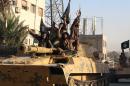 Islamic State militants patrol the Syrian city of Raqa