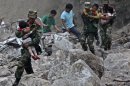 Soldiers carry children as locals follow them towards safer area after two earthquakes hit Zhaotong