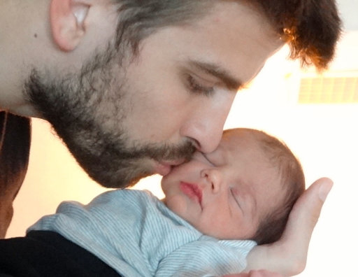 This undated image released courtesy of singer and UNICEF Goodwill Ambassador Shakira shows FC Barcelona star Gerard Piqué kissing the cheek of his son Milan, born Jan. 22 in Barcelona. The couple are inviting friends and fans to join their online baby shower to help provide life-saving items to children and communities in some of the poorest corners of the globe. After purchasing an Inspired Gift, they will then receive a personal thank you message from the couple. (AP Photo/courtesy of Shakira)