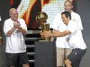Miami Heat coach Erik Spoelstra, right, grabs the NBA championship trophy as assistant coaches Ron Rothstein, left, and David Frizdale watch, in Miami on Monday, June 25, 2012. Hundred of thousands of people filled the streets of Miami for the Heat championship parade, and then 15,000 more got into the arena afterward for a long, loud reception for the NBA's new kings. (AP Photo/Alan Diaz)