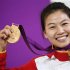 China's Yi Siling poses with her gold medal at the victory ceremony after the women's 10m air rifle final competition at the London 2012 Olympic Games in the Royal Artillery Barracks at Woolwich in London