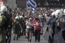 Man with Greek flag walks through line of Greek riot police during a 24-hour labour strike in Athens