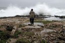 A man walks among the ruins of a home destroyed by Hurricane Sandy in Gibara, Cuba, Thursday, Oct. 25, 2012. Hurricane Sandy blasted across eastern Cuba on Thursday as a potent Category 2 storm and headed for the Bahamas after causing at least two deaths in the Caribbean. (AP Photo/Franklin Reyes)