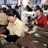 Employees work at a shoe factory in Dongkou county, Hunan province