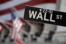 FILE - This May 11, 2007, file photo shows a Wall Street sign near the flag-draped facade of the New York Stock Exchange. Stocks are opening higher Thursday, Nov. 13, 2014, as traders welcome some more positive corporate earnings news. (AP Photo/Richard Drew, File)