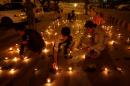 People light oil lamps to honour victims of the blast in Quetta during a vigil in Karachi,