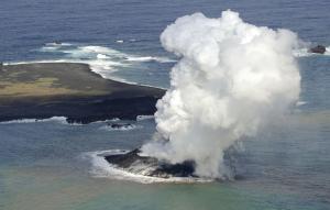 Smoke billows from a new island off the coast of Nishinoshima, …