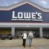 FILE - In this Feb. 20, 2011 file photo, a couple enters a Lowe's store in Dallas. Lowe's Cos. said Monday, Nov. 14, 2011, its third-quarter earnings sank 44 percent, weighed down by charges tied to store closings and discontinued projects. (AP Photo/LM Otero, File)