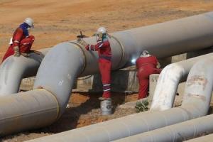 Oil workers weld a new pipeline at PDVSA's Jose Antonio Anzoategui industrial complex in the state of Anzoategui