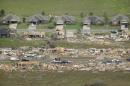 A row of lightly damages houses, top, face destroyed homes in a Vilonia, Ark., neighborhood Monday, April 28, 2014 after a tornado struck the town late Sunday, killing at least 16 people. (AP Photo/Danny Johnston)