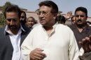 In this Monday, April 15, 2013 photo, Pakistan's former President and military ruler Pervez Musharraf arrives under tight security to address his party supporters at his house in Islamabad, Pakistan. Musharraf and his security team pushed past policemen and sped away from a court in the country's capital on Thursday after his bail was revoked in a case in which he is accused of treason. (AP Photo/B.K. Bangash)