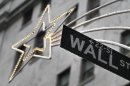 A holiday decoration is seen over Wall St. sign outside the New York Stock Exchange