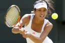 Hsieh Su-Wei of Taiwan hits a return to Maria Sharapova of Russia during their women's singles tennis match at the Wimbledon tennis championships in London