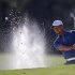 Tiger Woods of the U.S. hits from a sand trap on the 17th green during third round play in the 2013 Masters golf tournament in Augusta